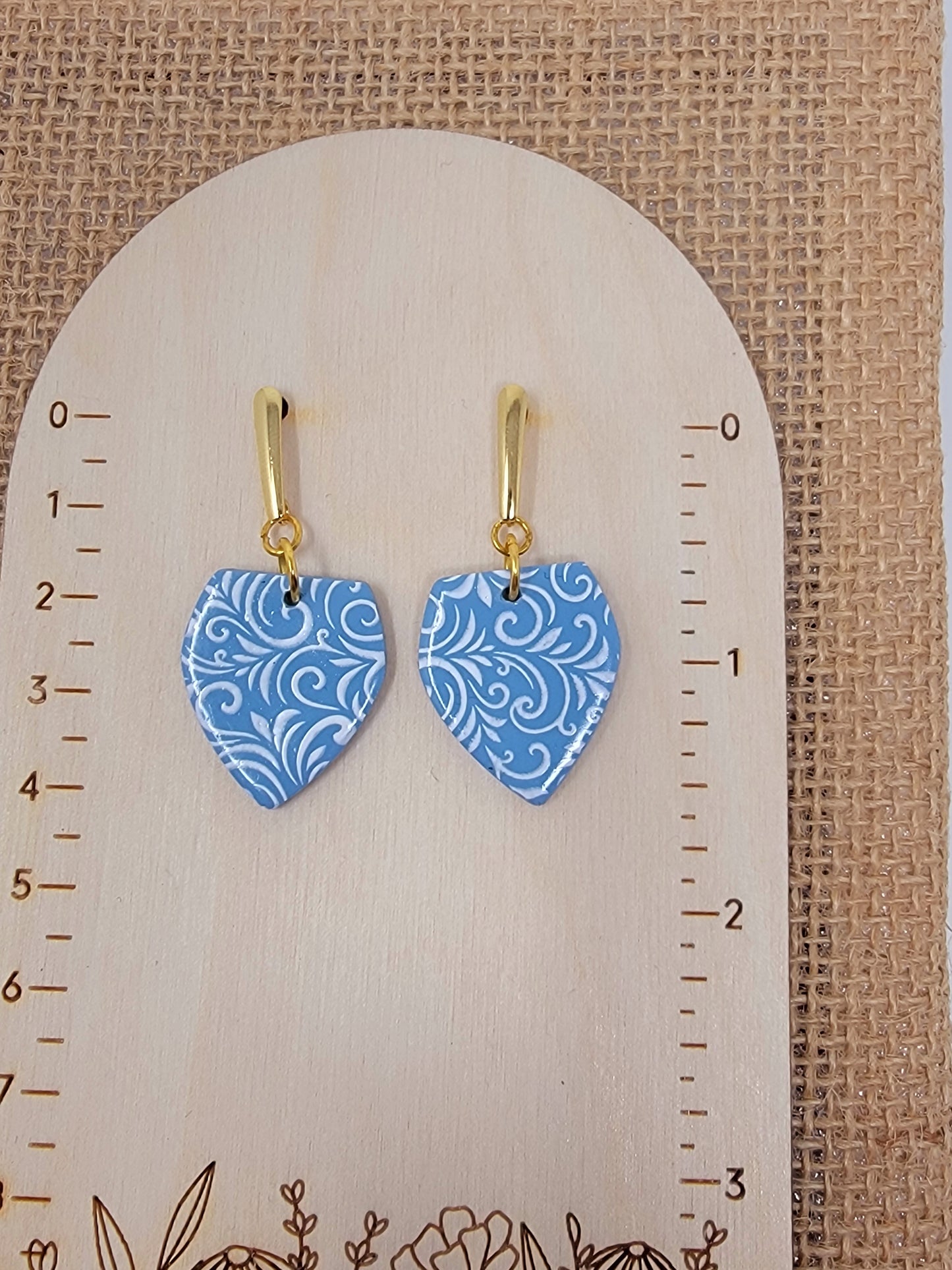 Blue and white dangles with gold accent top