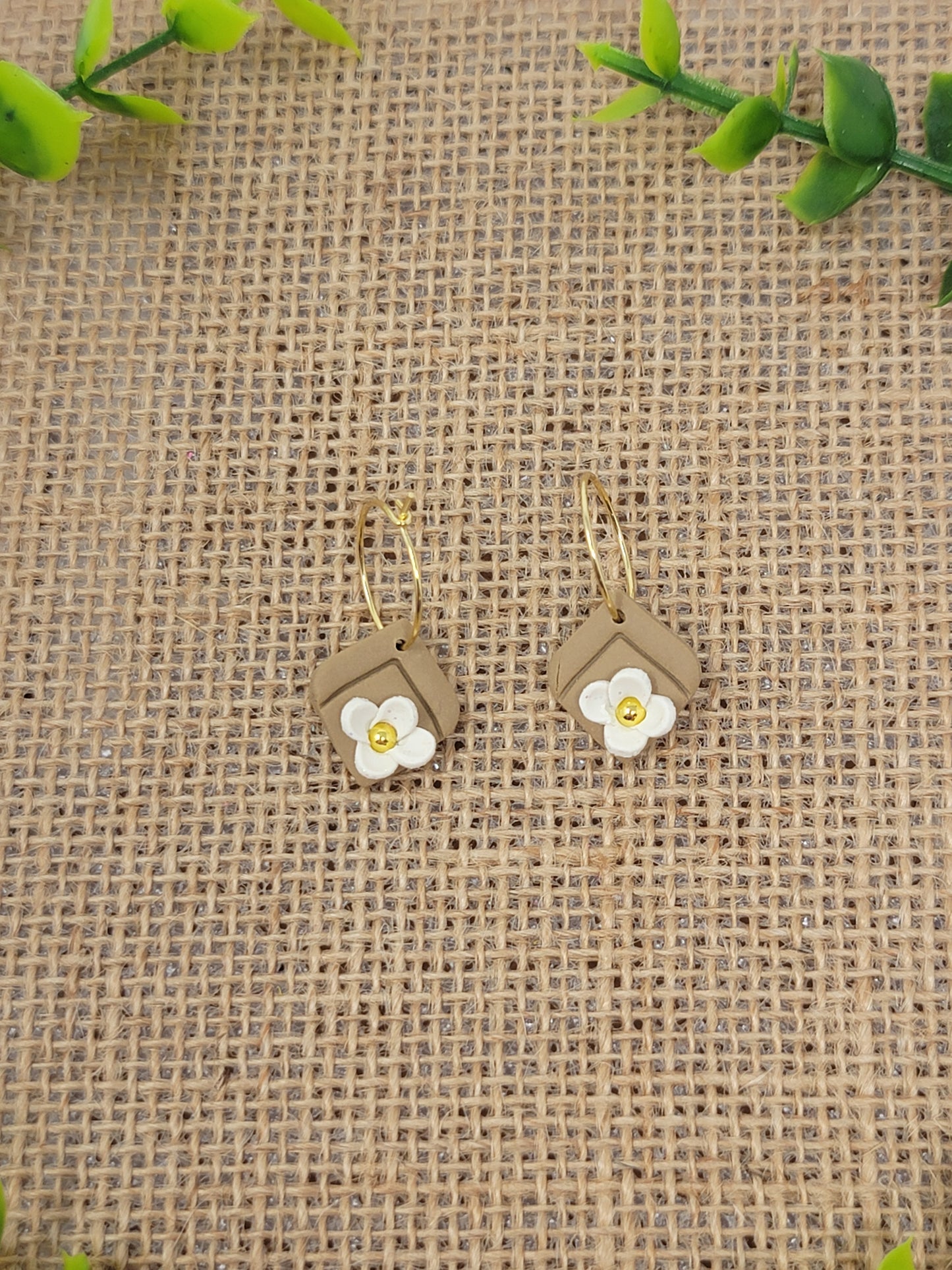 Tan gold hoops with white flower accent
