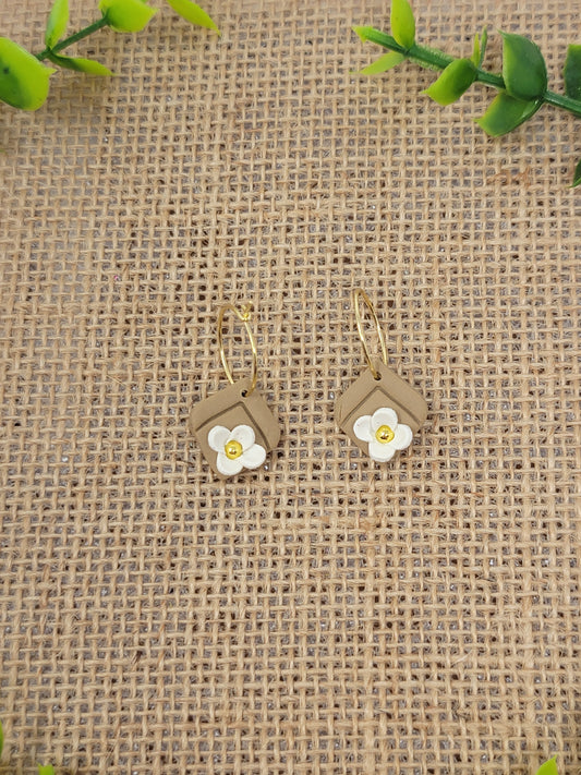 Tan gold hoops with white flower accent