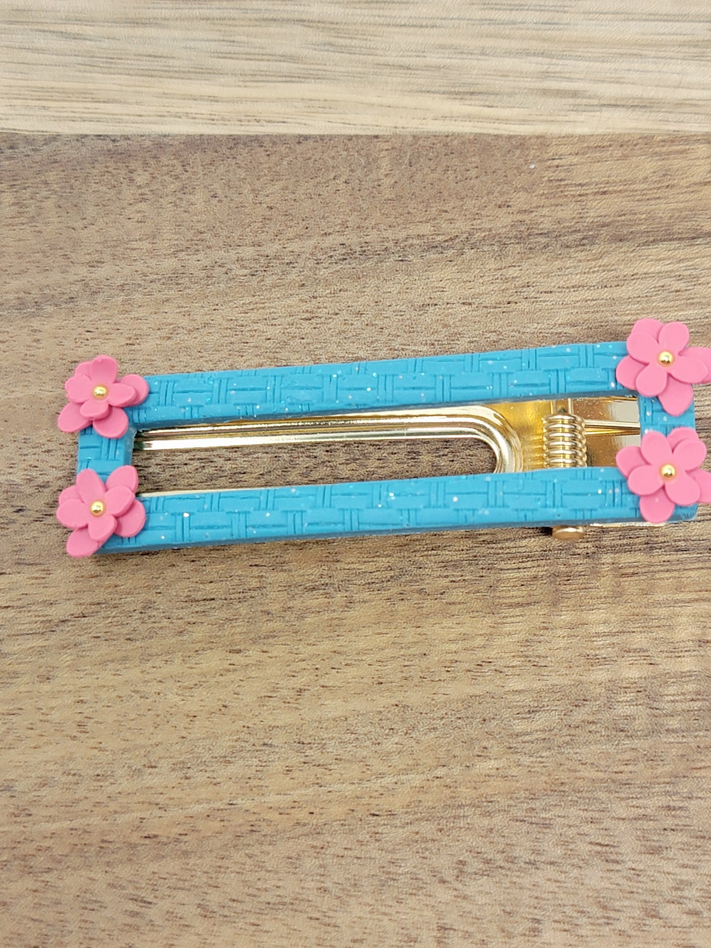 Blue hair clip with pink flower