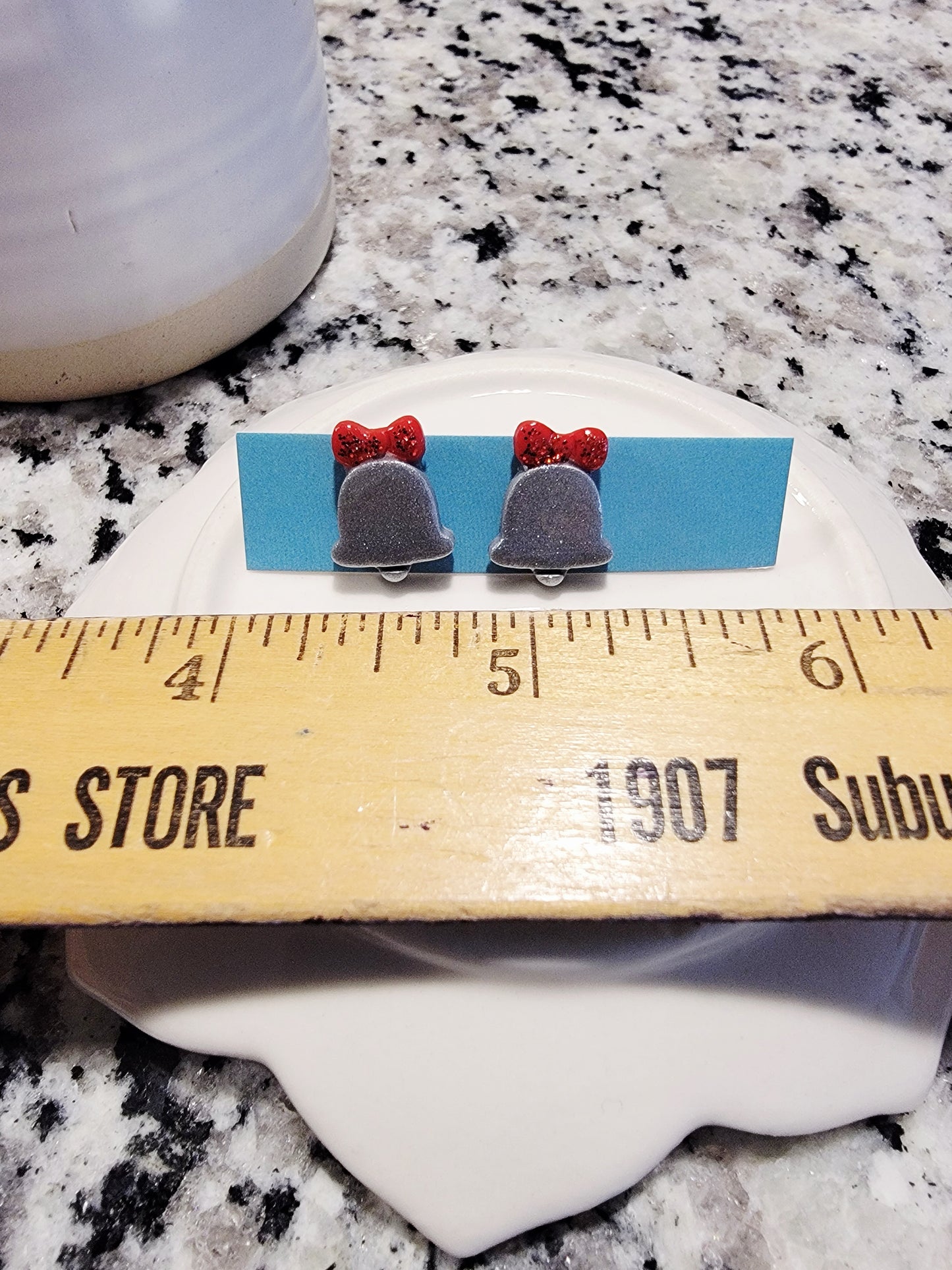 Silver bell with red bow studs