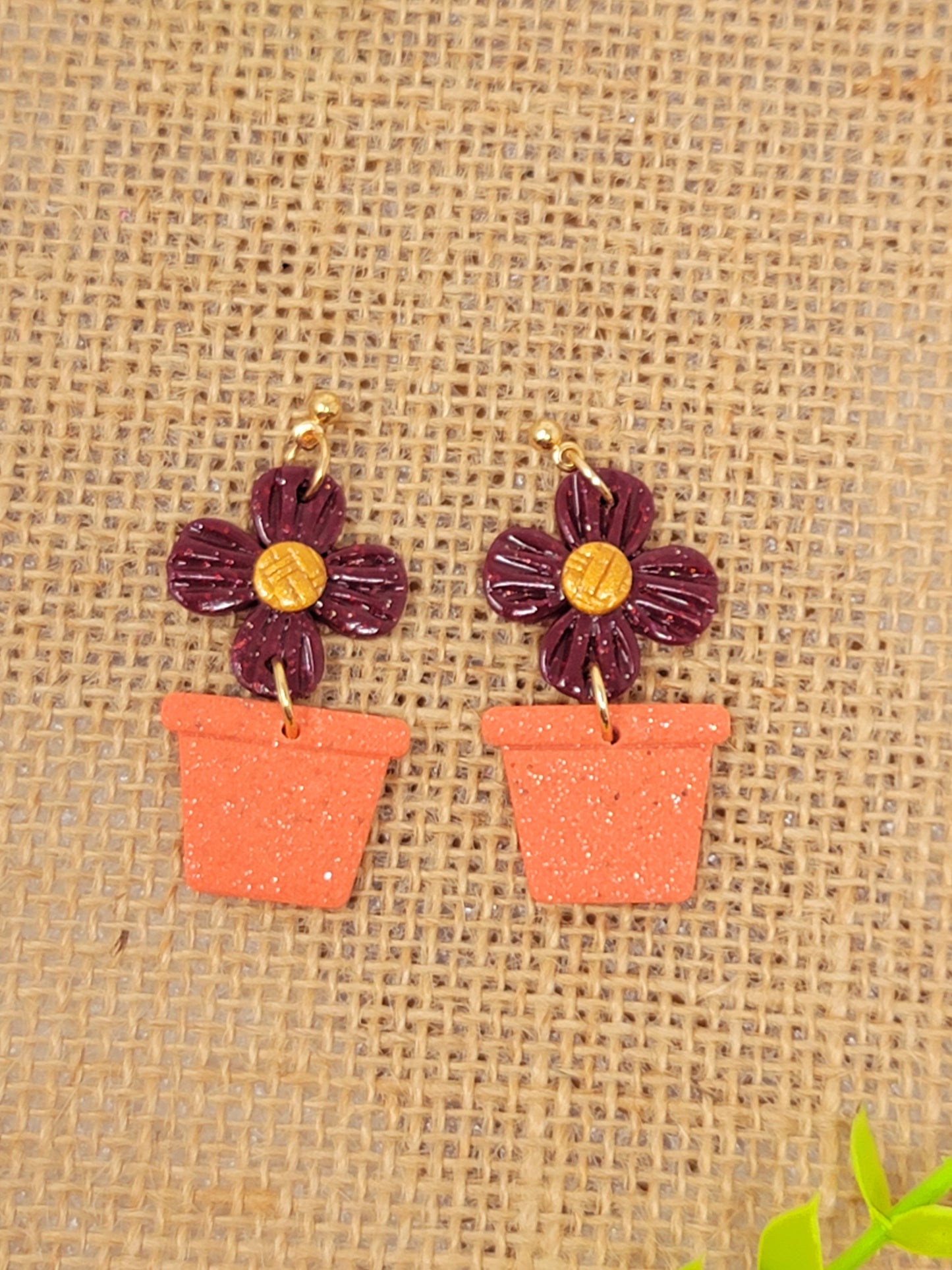 Sparkly dark red potted plant dangles