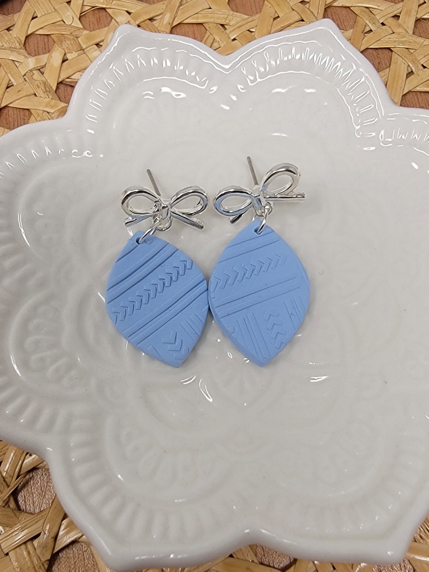 Light blue dangles with silver bow top