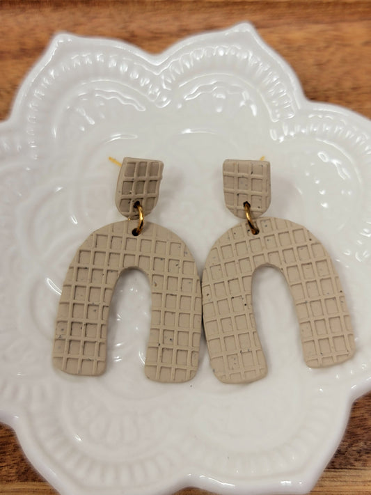 Textured tan arch dangles