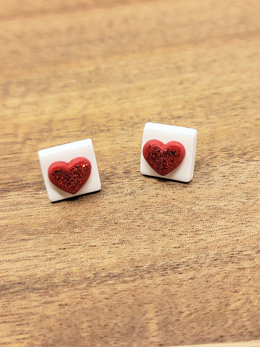 White square studs with glittery red heart