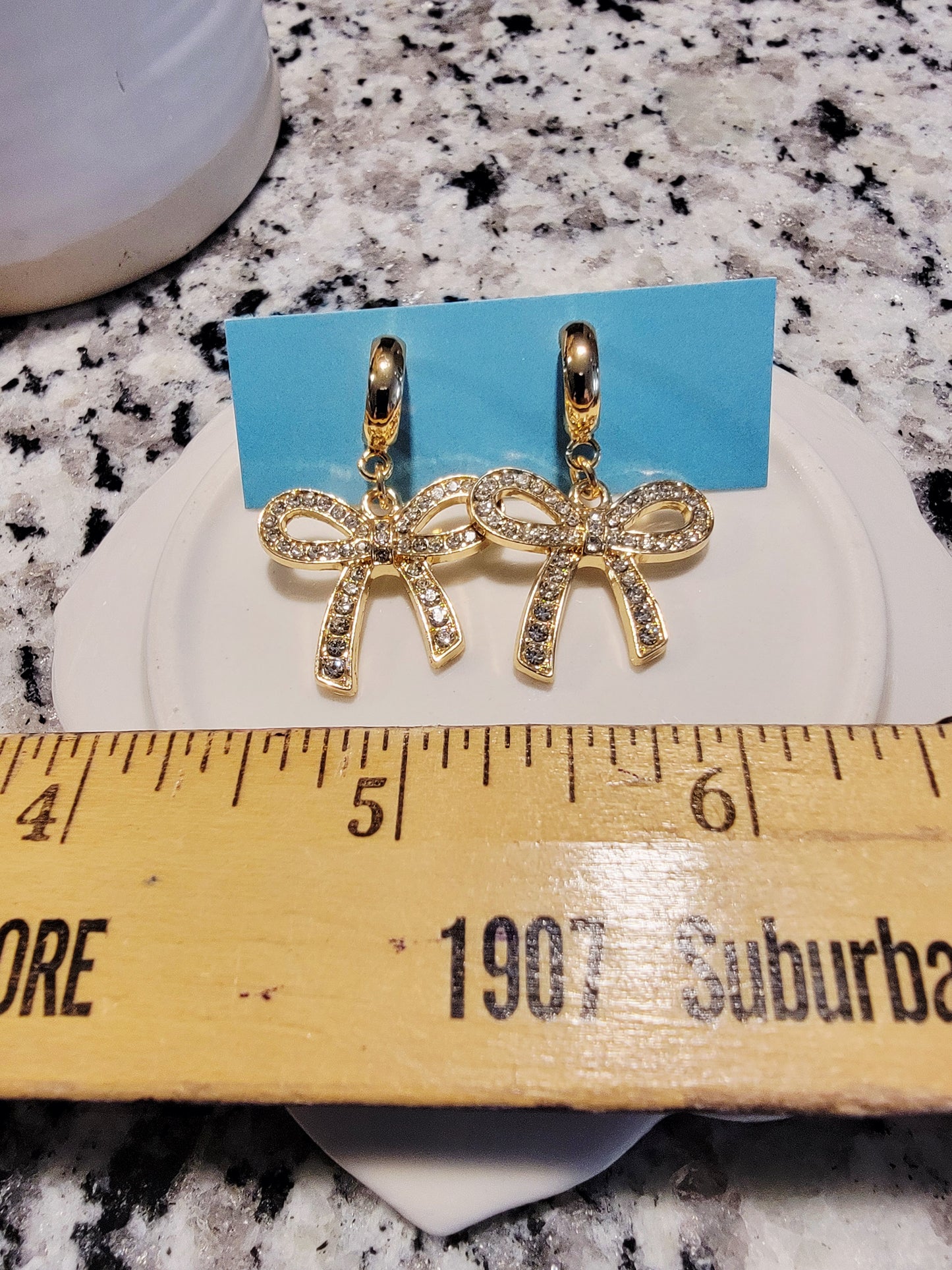 Gold bow charm dangles