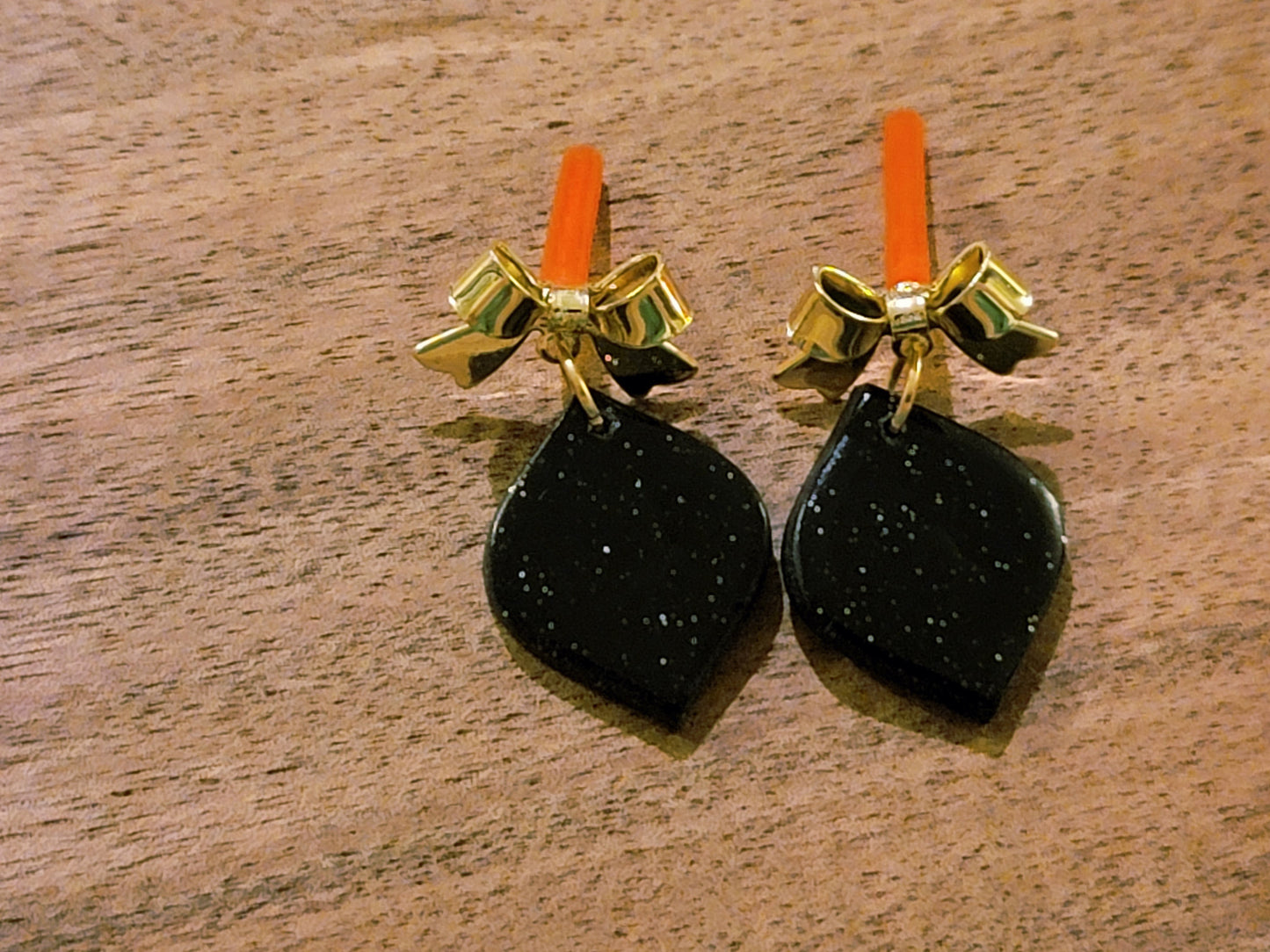Black dangles with gold bow